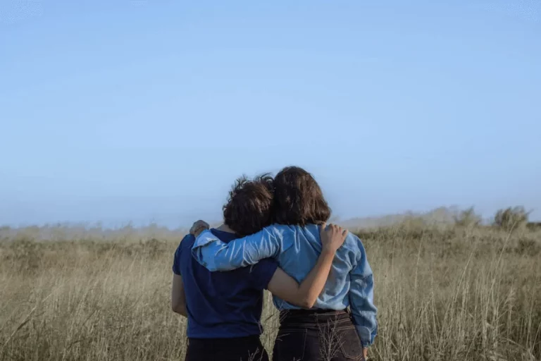 two people sidehugging